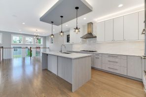 Gray zone of the central kitchen island and steampunk starburst black metal lamps over it