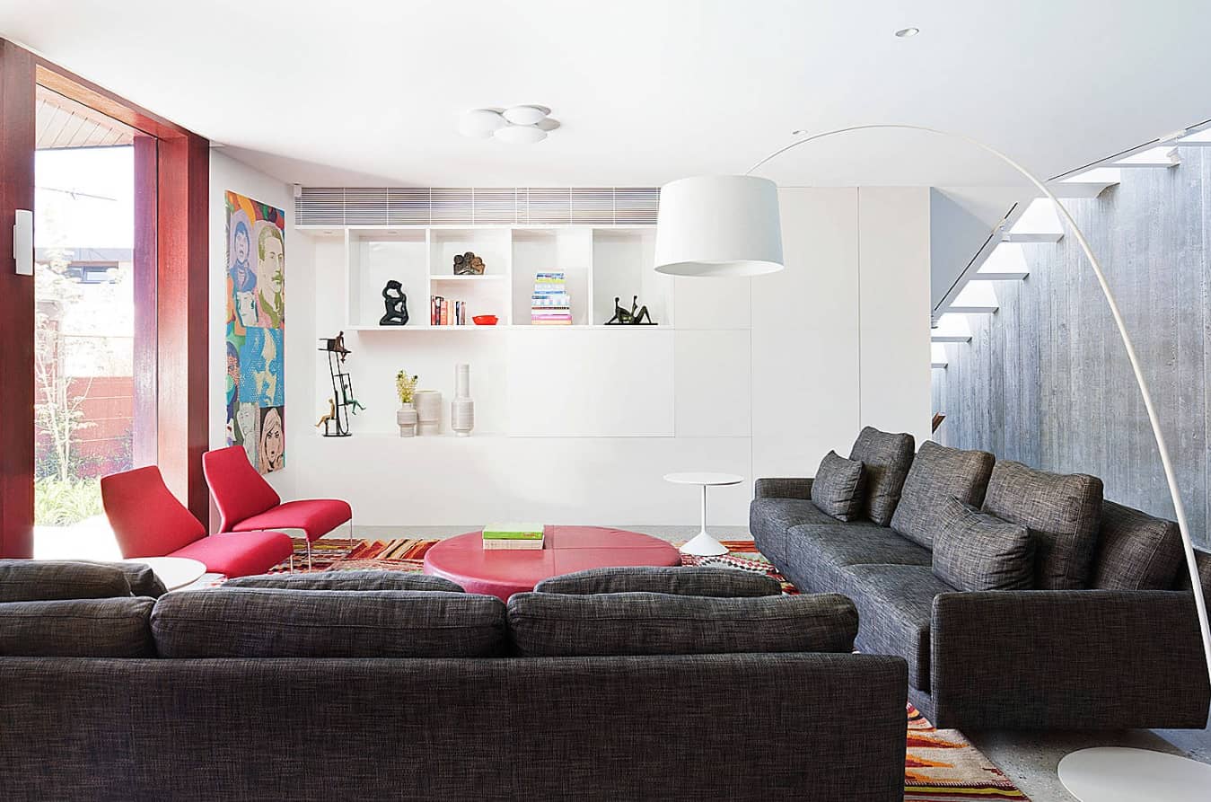 Your Dream Home: How Too Many Customizations Can Make It Hard to Sell. Stunning modern interior in white with a lot of storage spaces and dark sofa in living zone
