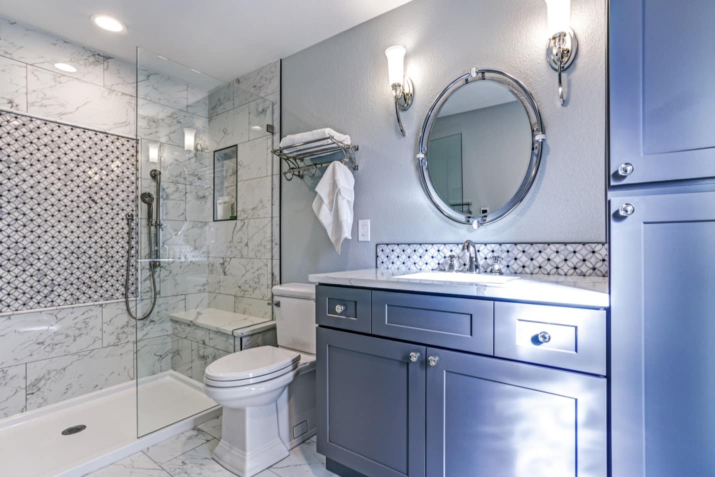 Spruce up Your Washroom: 8 DIY Shower Remodeling Ideas. Marble wall finishing in the shower zone and gray painted walls in the rest of the bathroom