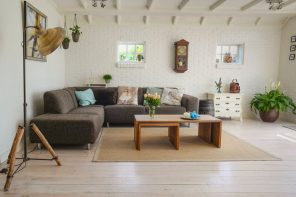 Simple Yet Effective Home Updates to Help You Sell Your Home. Large simple styled minimalistic living zone with dark gray sofa and wooden coffee table