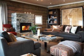 The Overview and Examples of Norwegian Interior Design. Rustic interior with wooden walls and stone trimmed fireplace