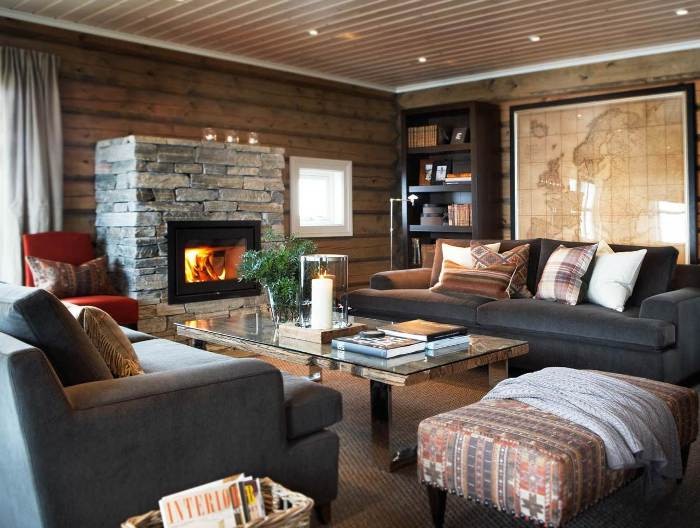 The Overview and Examples of Norwegian Interior Design. Rustic interior with wooden walls and stone trimmed fireplace