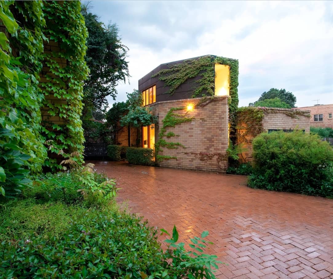 8 Benefits of Installing Brick Pavers. Greenery and pavement for suburb English style house