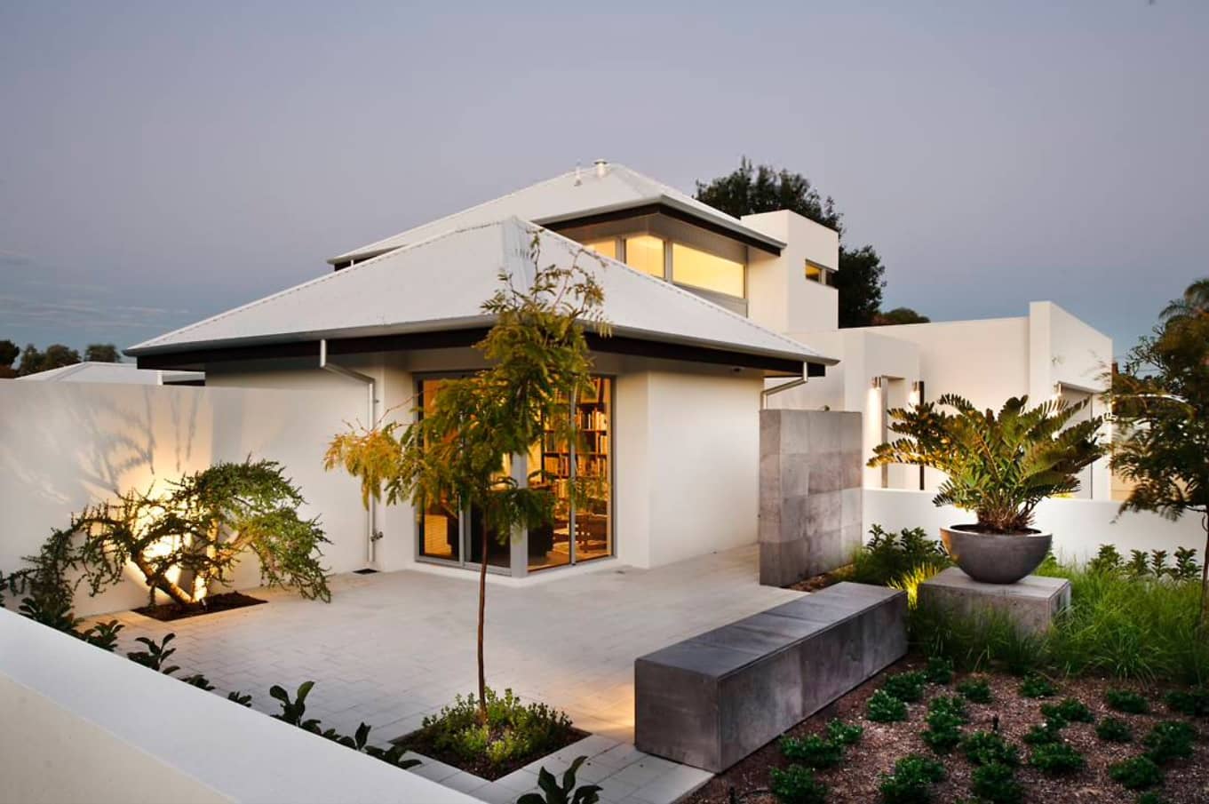5 Significant Reasons For Maintaining Your Roof Regularly. White modern house with hip and valley roof type and neat concreted yard