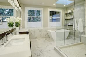 7 Genius tips to deep clean a bathroom. Great bathroom interior design in light marble color and boundless glass shower cabin