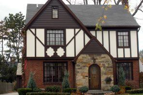 Tudor Interior Design Style History and Examples. White facaded house with stone and dark wooden decoration