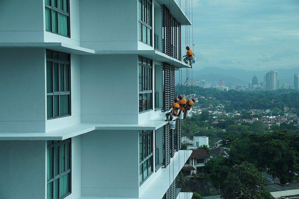 Home Maintenance Checklist 2020. Cleaning windows on scaffold