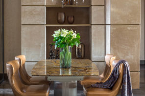 Brown leather dining chairs on scissor frame to finish the composition with marble top table