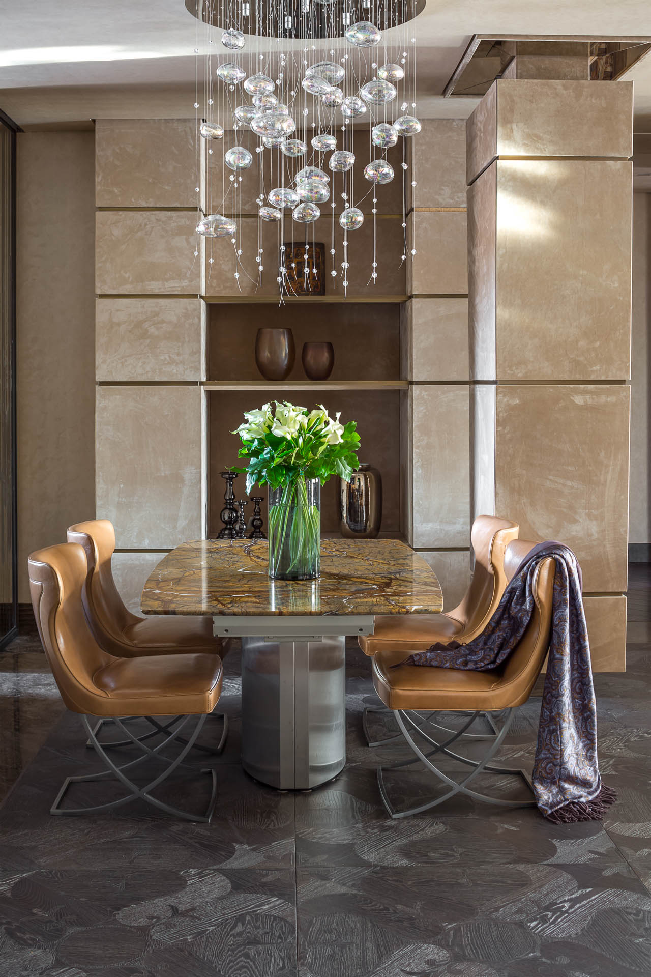 Brown leather dining chairs on scissor frame to finish the composition with marble top table