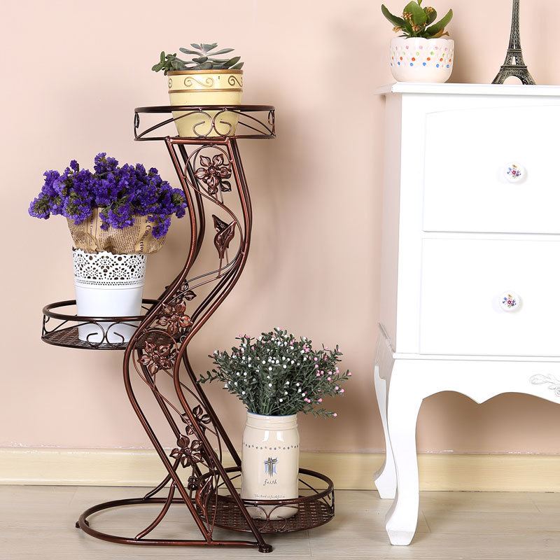 Flower Stands as Interior Complement: Fresh Ideas for Different Designs. Figured and forged stand with three slots