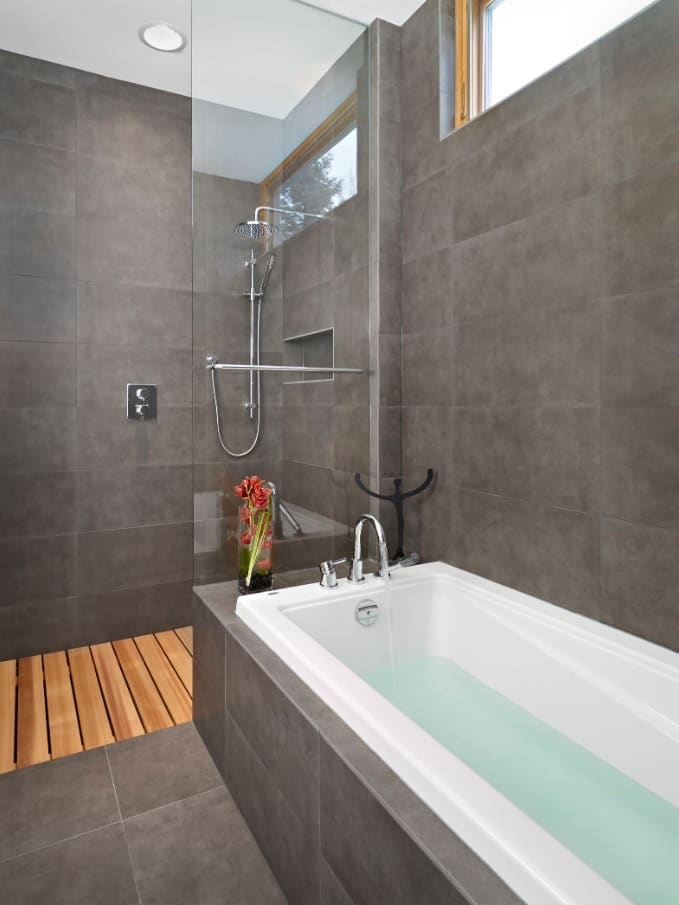 Disclosures You Should Make When Selling Your Home in Edmonton. Great modern design of the bathroom in large gray ceramic tile