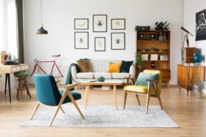 Casual living room with wooden lounge chairs and similar table and picture decorated wall