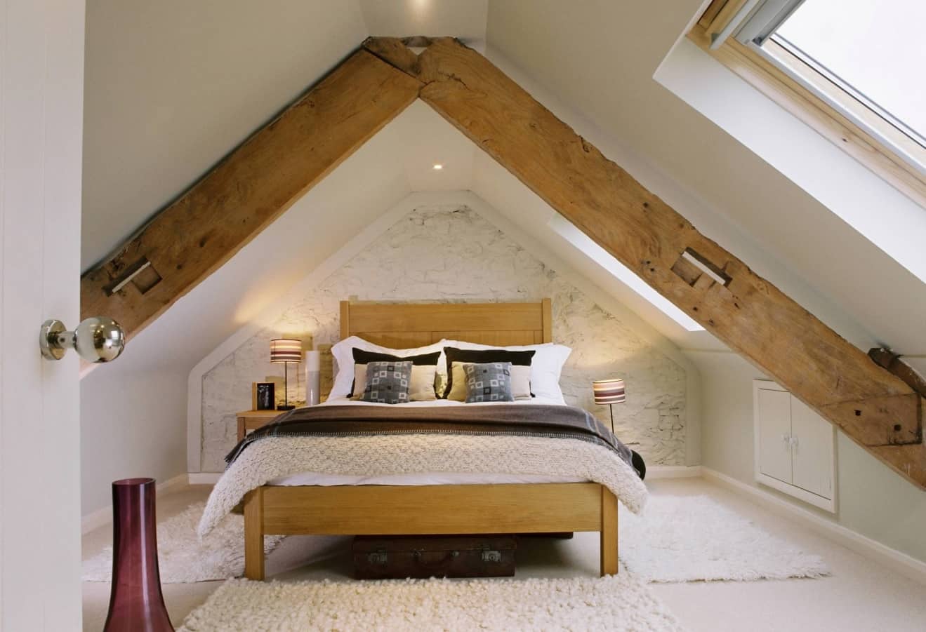 8 Best Loft Conversion Ideas for 2020. Chic lof bedroom with exposed wooden beams
