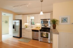 Seasonal Cleaning Tips. Great neat kitchen design with hardwood floor and steel surfaces of appliances