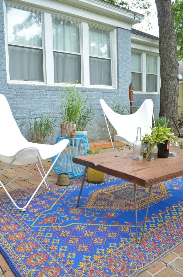 Outdoor Must-Haves for Your Tiny Home. Cafe chairs and simple wooden table on the carpet