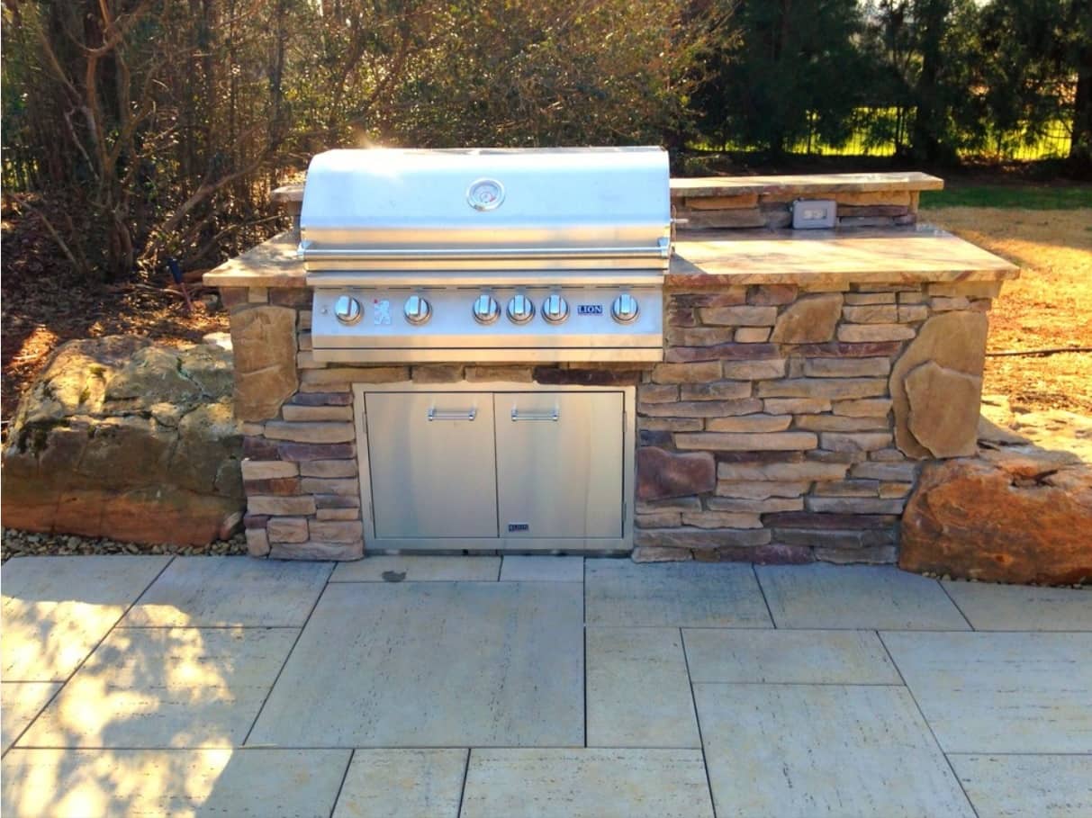 Outdoor steel shiny grill mount into the stone countertop