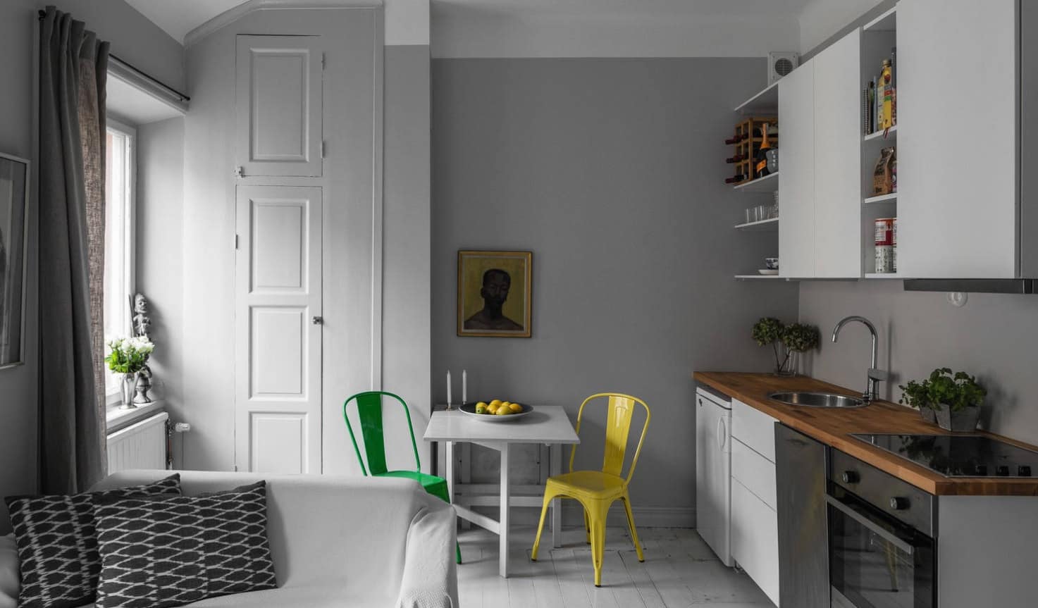 10 Tips on Remodeling Kitchens for New Homeowners. Gray wall and colorful chairs for small dining area