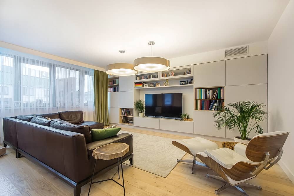 Cool apartment with TV set, a leather brown sofa and soft leather armchair