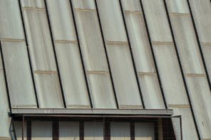 The Pros and Cons of Corrugated Roofing. Small window built into the roof