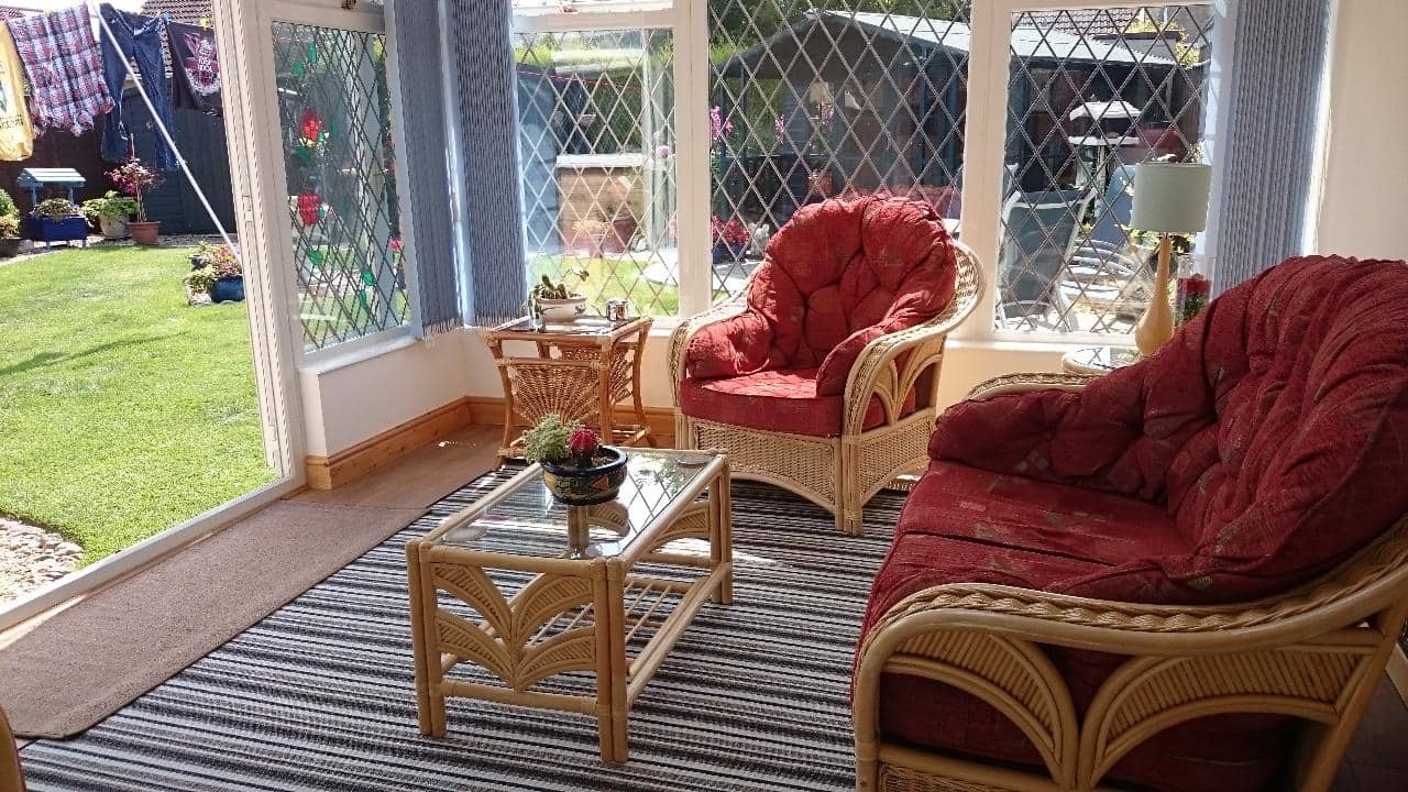 5 Ways You Can Liven Up Your Backyard. Homey lounge with bright red classic furniture at the deck
