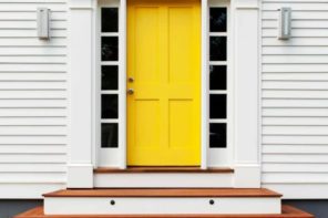 Simple house exterior design with yellow classic front door