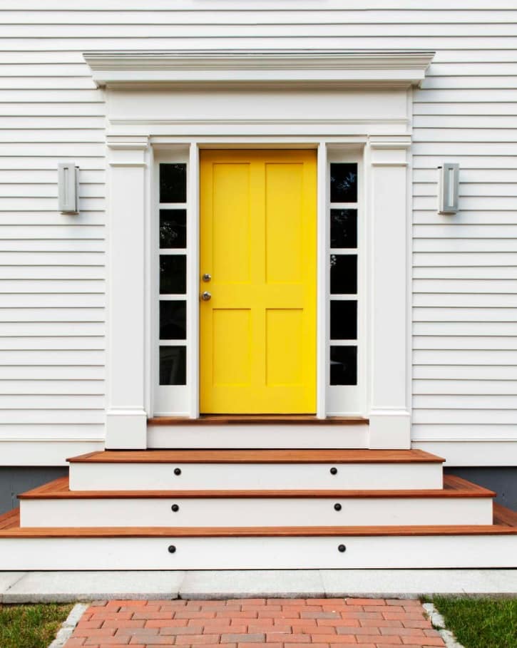 Simple house exterior design with yellow classic front door 