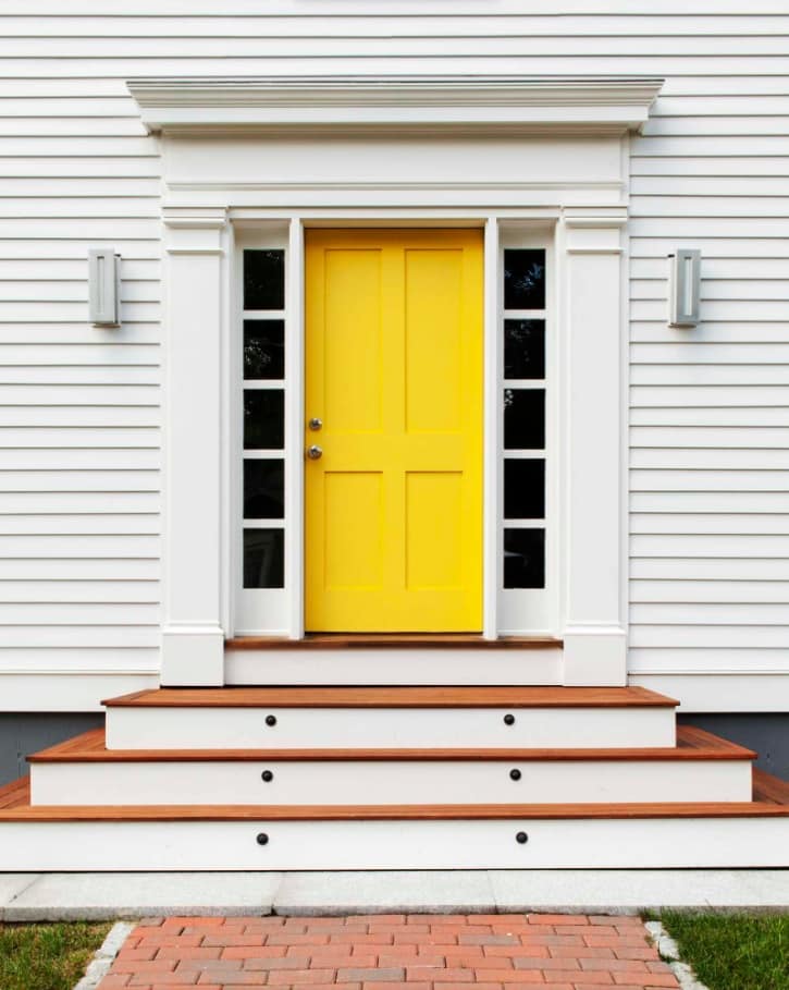 Simple house exterior design with yellow classic front door