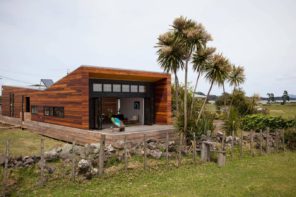 Wooden trimmed modern cottage at the rocky foundation