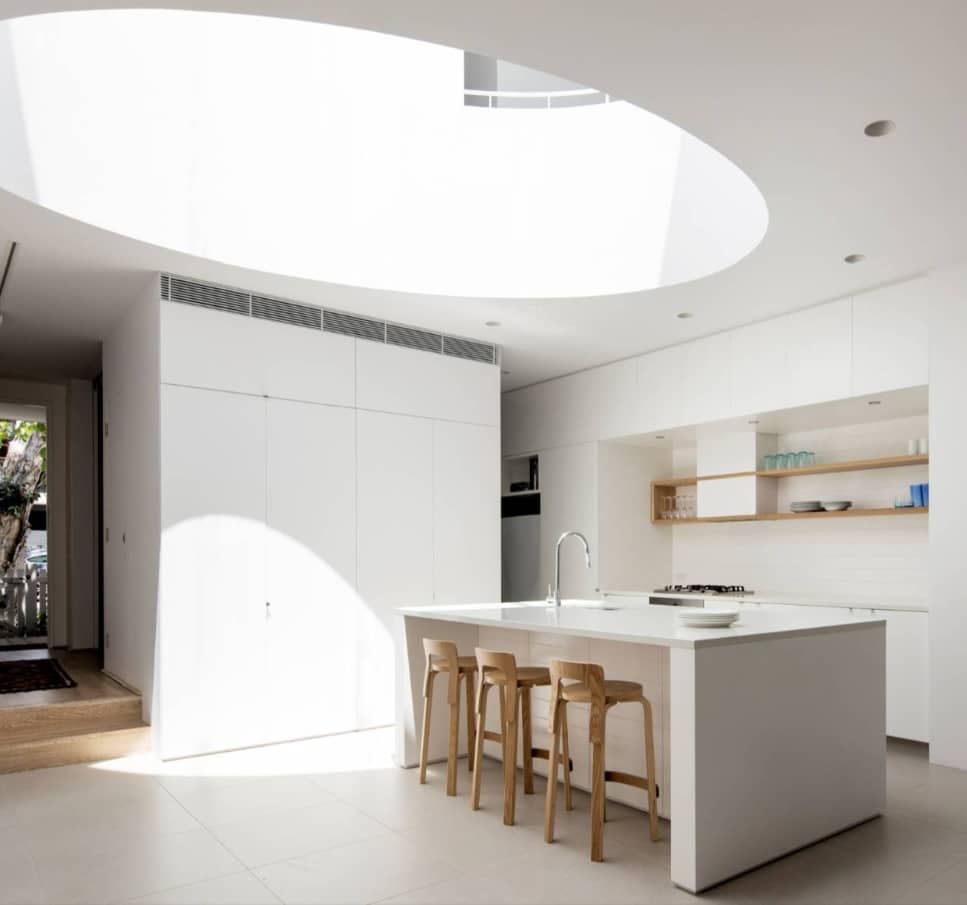 Big circle skylight in the center of modern styled large kitchen in white