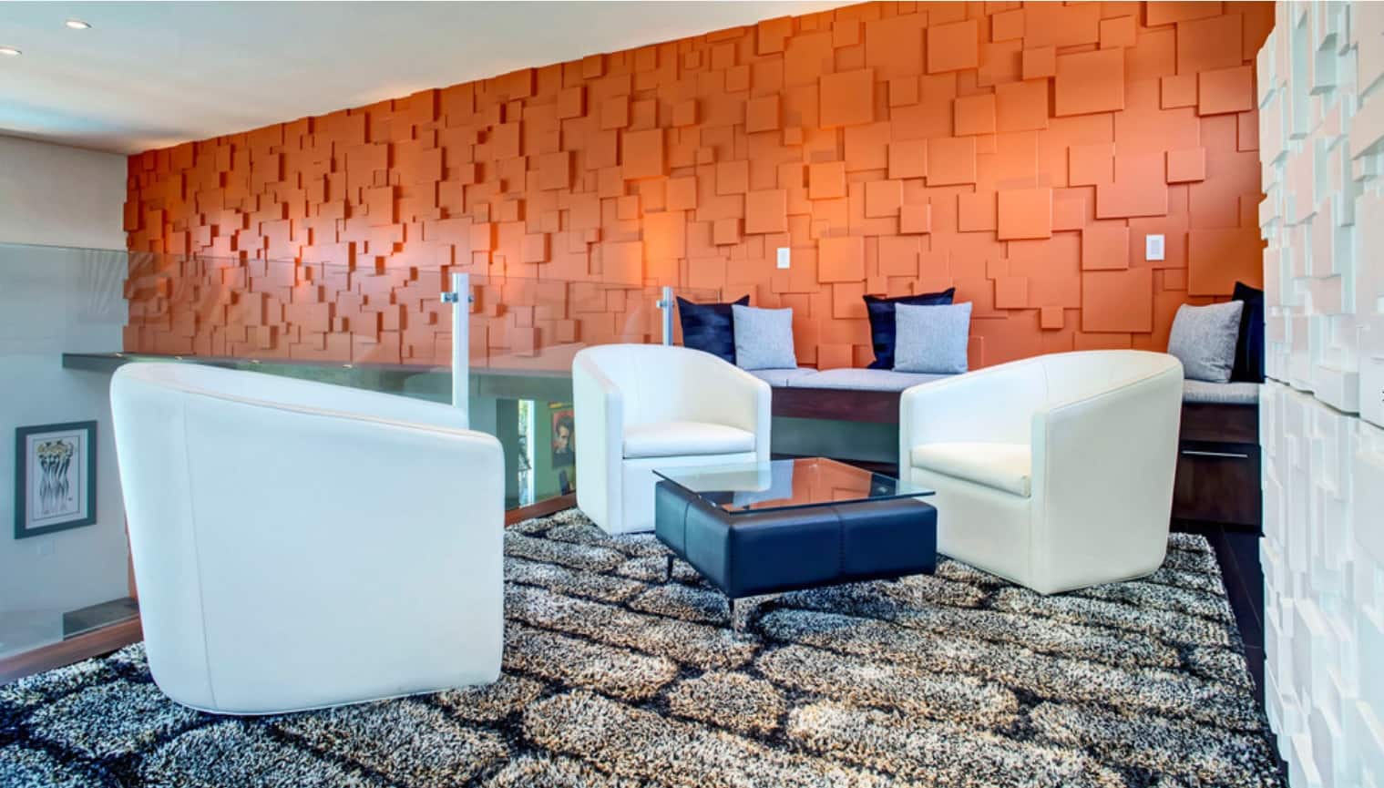 Striking orange textured walls for spacious chatting area