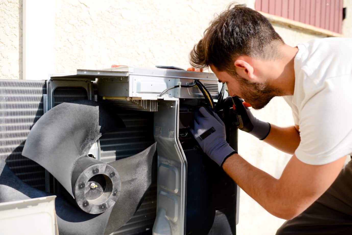 6 Signs It's Time to Say Goodbye to Your Old AC Unit. Repairing the AC by specialist at the roof