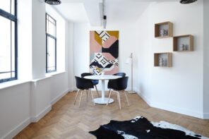 White and black contrast at the dining zone with luxurious cow's pelt to decorate the available parquet floor space