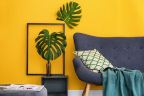 Things to Consider When Doing Major Design Changes in Your Home. Large plant at the background of yellow wall with decorative photo frame