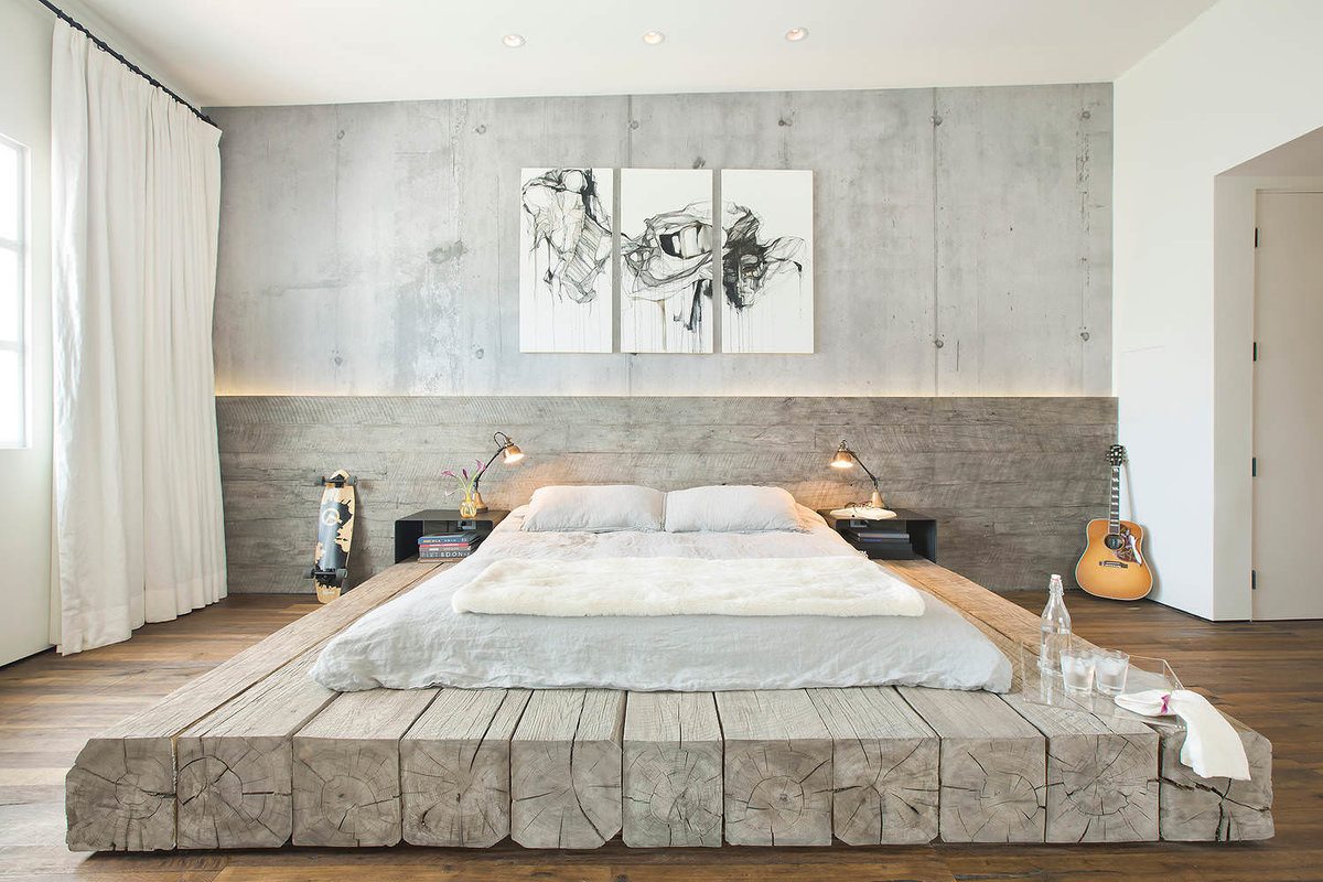 Log set large bed platform and faux concrete painted walls in the urbanistic bedroom