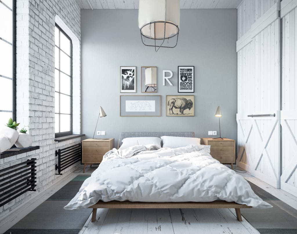 Simple decorated bedroom with gray walls and whitewashed brickwork accent
