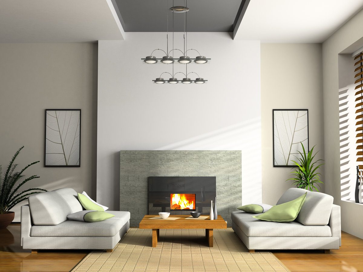 White accent wall with cladded artificial fireplace and low coffee table in front