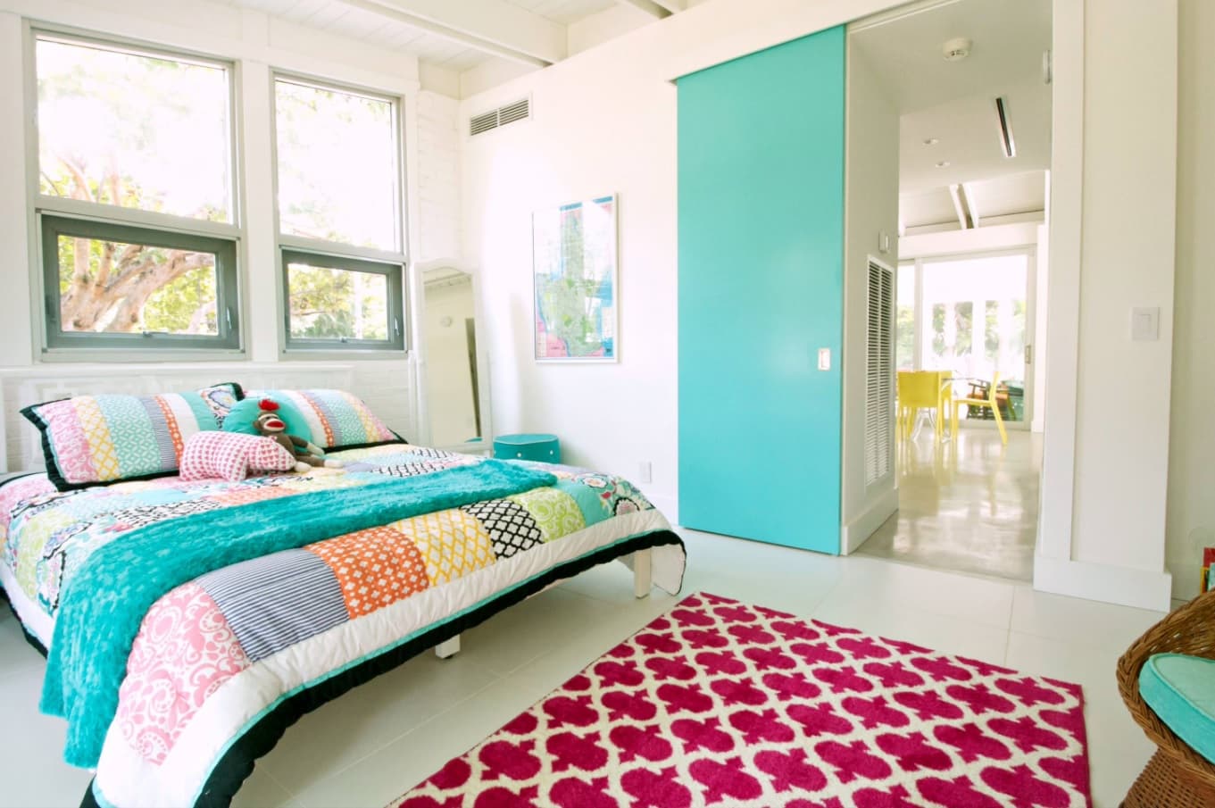 4 Must-Have Bed Coverings You Cannot Miss. Unusual modern styled design of the room with red patterned rug and turquoise sliding door