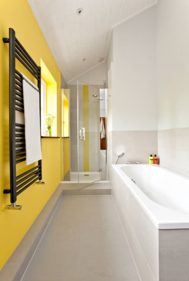Making the Most of a Small Bathroom. Nice modern design in the compact space with accent yellow wall and black wall heater