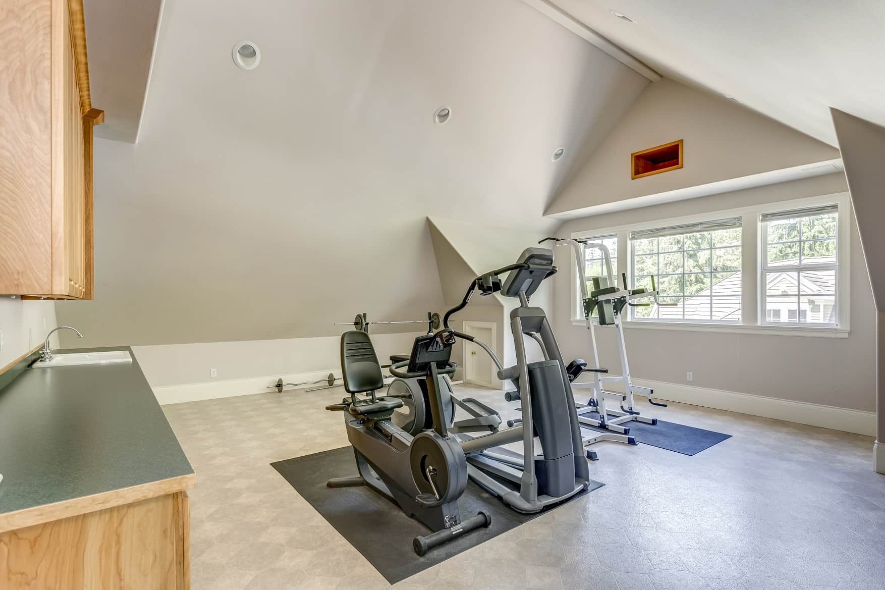 4 Tips to Create a Home Gym Out of a Small Space. Exercise bike at the loft improvised gym