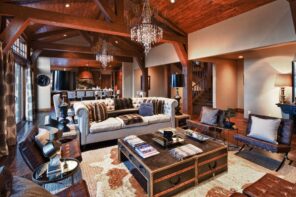 great castle looking interior design with wooden transom ceiling, cow pelts and chest coffee table