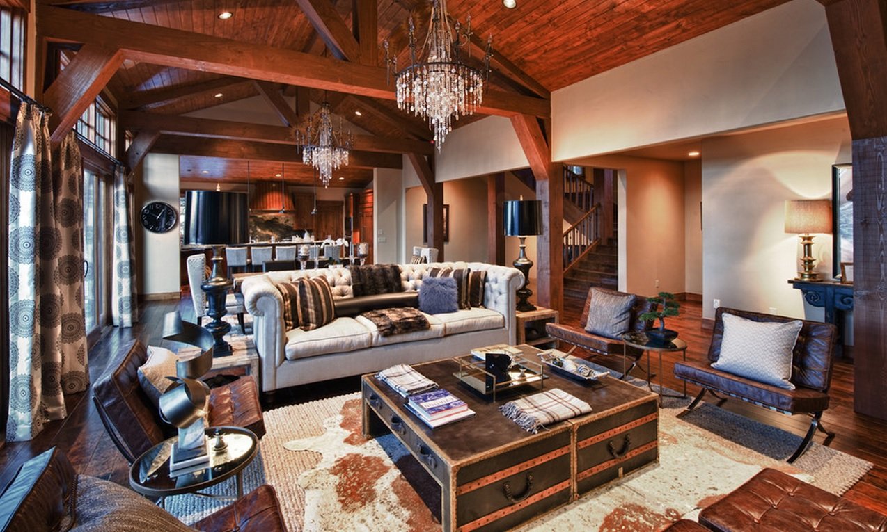 great castle looking interior design with wooden transom ceiling, cow pelts and chest coffee table