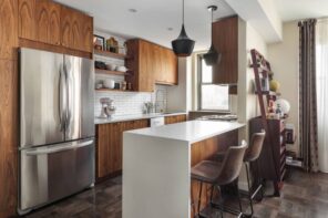 Why Are Kitchen Cabinets So Expensive? great modern designed kitchen with hung cabinets and steel double-sided fridge