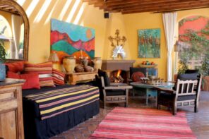 Spanish Interior Design Style Overview. White walls and colorful textiled for large living room