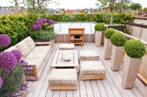 Top Tips for Designing Your Patio. Modern design with wooden coffee table and bonsai flowers in high concrete vases