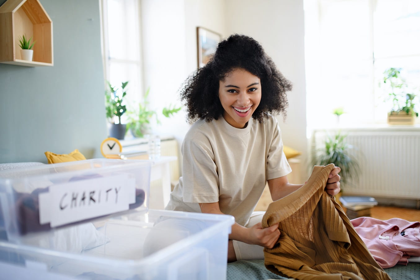 5 Reasons To Donate Your Old Belongings. Sorting the clothes for donation