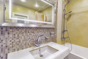 Mosaic tile, rectangular mirror with neat contour lighting for nice casual bathroom