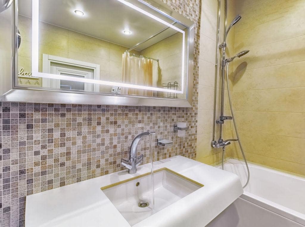 Mosaic tile, rectangular mirror with neat contour lighting for nice casual bathroom