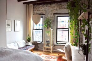 7 Methods for Eco-Friendly Home Renovation. Loft interior with rough whitewashed wall, simple wooden shelving with plants and overall casual design in light pastel colors