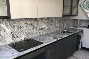 A Guide To Using Granite In Your Kitchen. Great casual interior design with backsplash and countertop in the same structure of marble imitating slabs