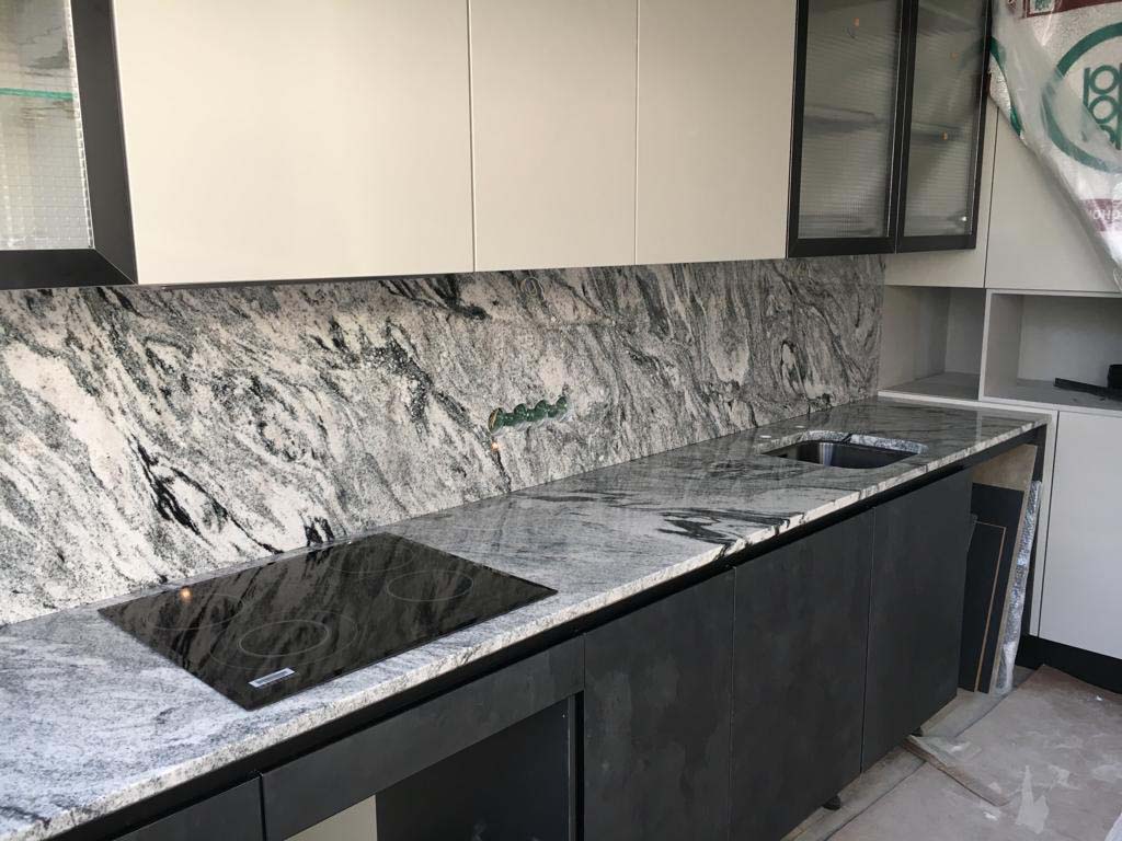 A Guide To Using Granite In Your Kitchen. Great casual interior design with backsplash and countertop in the same structure of marble imitating slabs